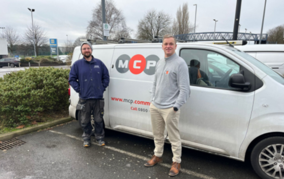 Image of two workers Infront of MCP van