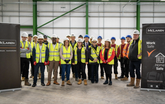 Group of workers in warehouse with banners on either side