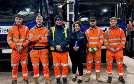 Star scaffolding workers Infront of trucks