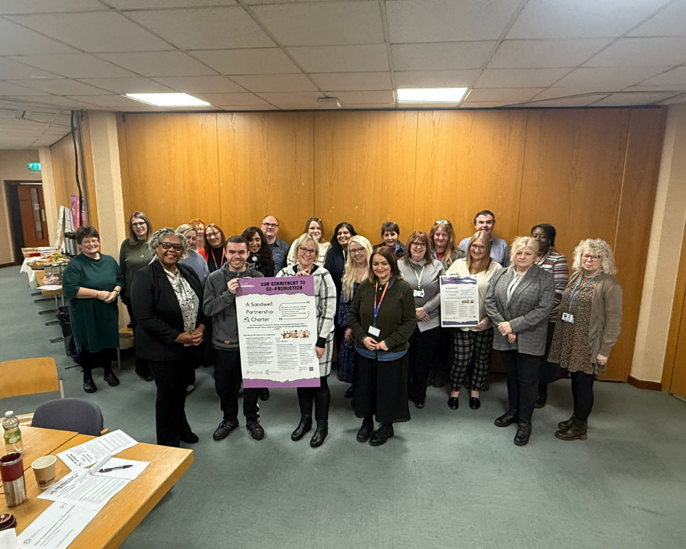 People involved in shaping the Charter stand together