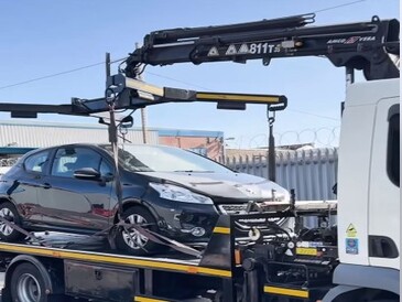 Abandoned car on back of pick up trick