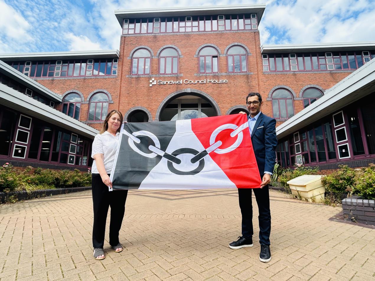 Cllr Kerrie Carmichael and Shokat Lal raise the Black Country flag
