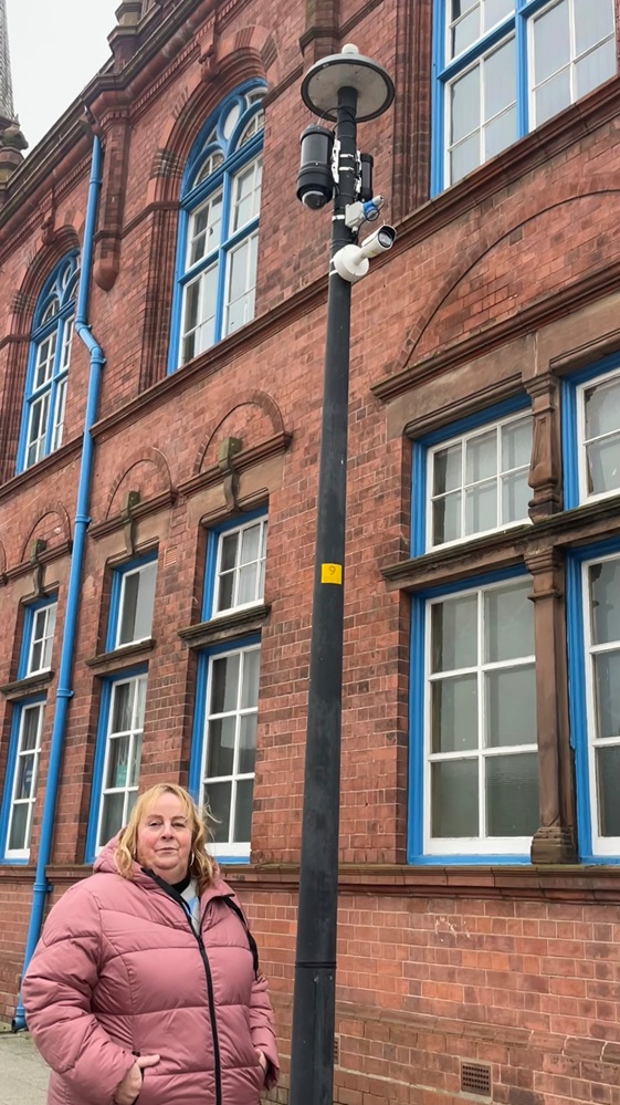 Councillor Suzanne Hartwell with a CCTV camera helping to tackle fly-tipping