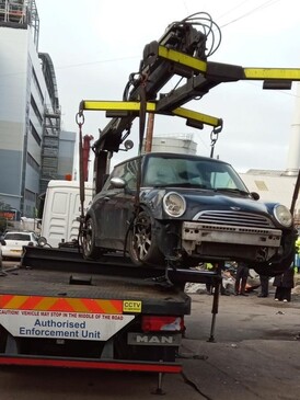 abandoned car being lifted