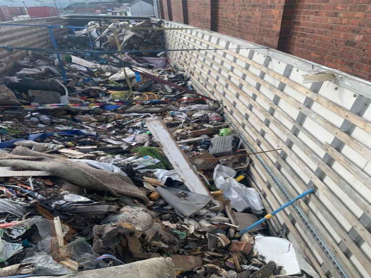 Piles of building waste and household rubbish in a large trailer