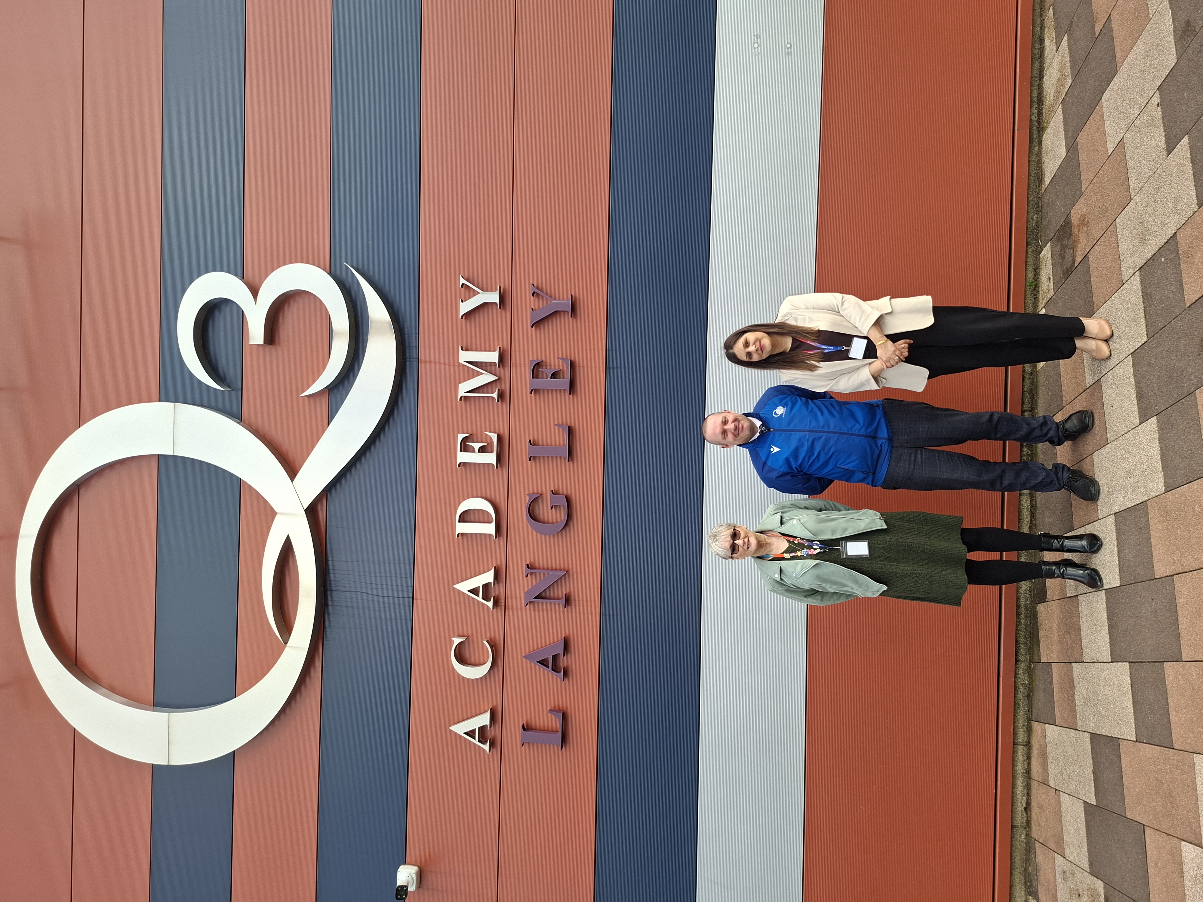 Image of Louise Morris School Attendance Manager for Sandwell Council, Headteacher of Q3 Langley, Peter Lee and Councillor Harnoor Bhullar, Sandwell Council’s Cabinet Member for Education in front of Q3 Academy sign
