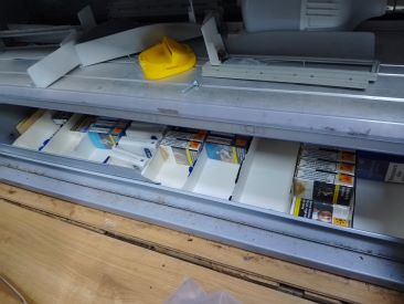 Concealed storage area for illegal tobacco products in retail store