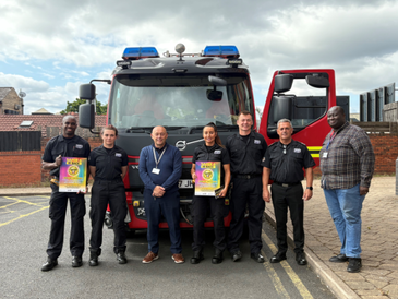 Safer 6 team with promotional material in front of fire engine
