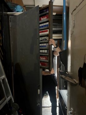 Hidden concealment of illegal cigarettes and tobacco products hidden inside a cupboard door