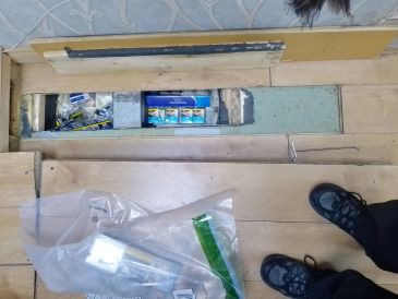 Concealed storage in floor found to contain illegal tobacco products