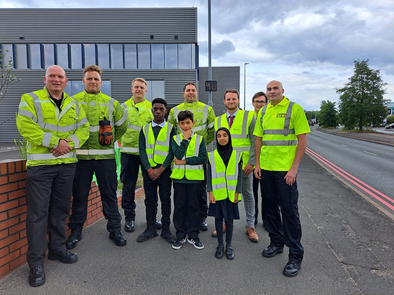 Officers from White Watch, Oldbury Fire Station with school children Gideon, Yuvraj, and Safa and their class teacher, Joe Watson
