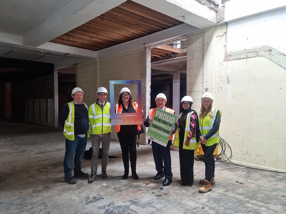 Individuals standing in the location of the new indoor market in West Bromwich